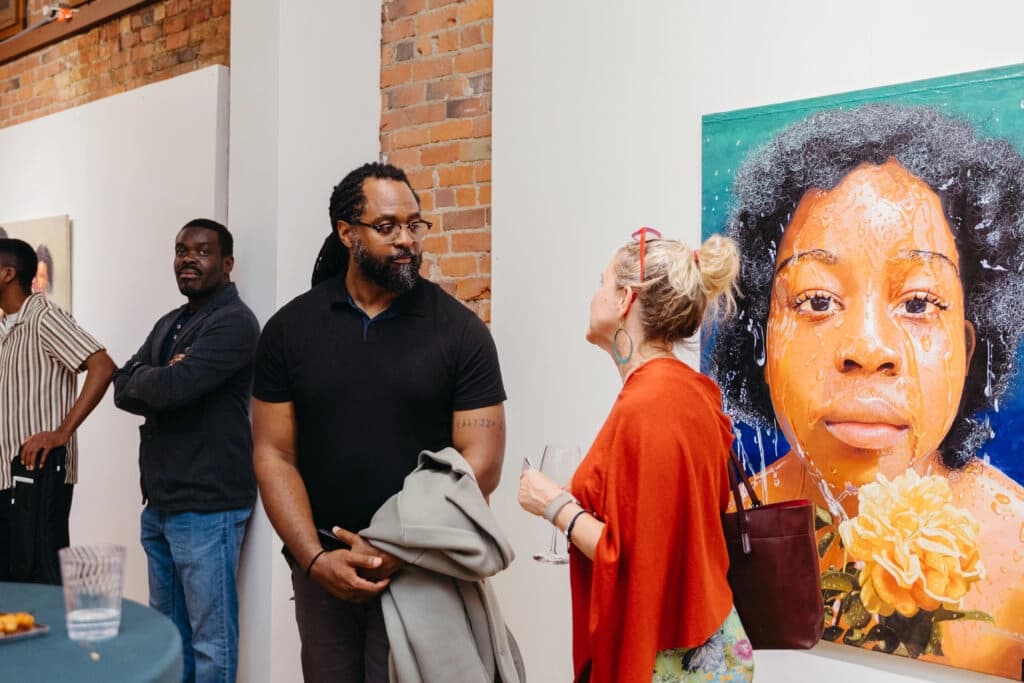 Community members in conversation at an Ensemble Washington art event